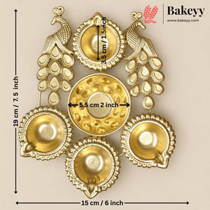 Gold-toned decorative wall hanging with peacock motifs and five bowl-like ornaments, shown on a beige background with overlaid dimensions and the Bakeyy brand mark.