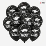 Black balloons with 'Congratulations Grad' text and graduation caps on a white background