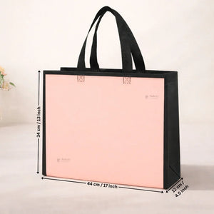 Pink tote bag with black handles and measurements on a light background