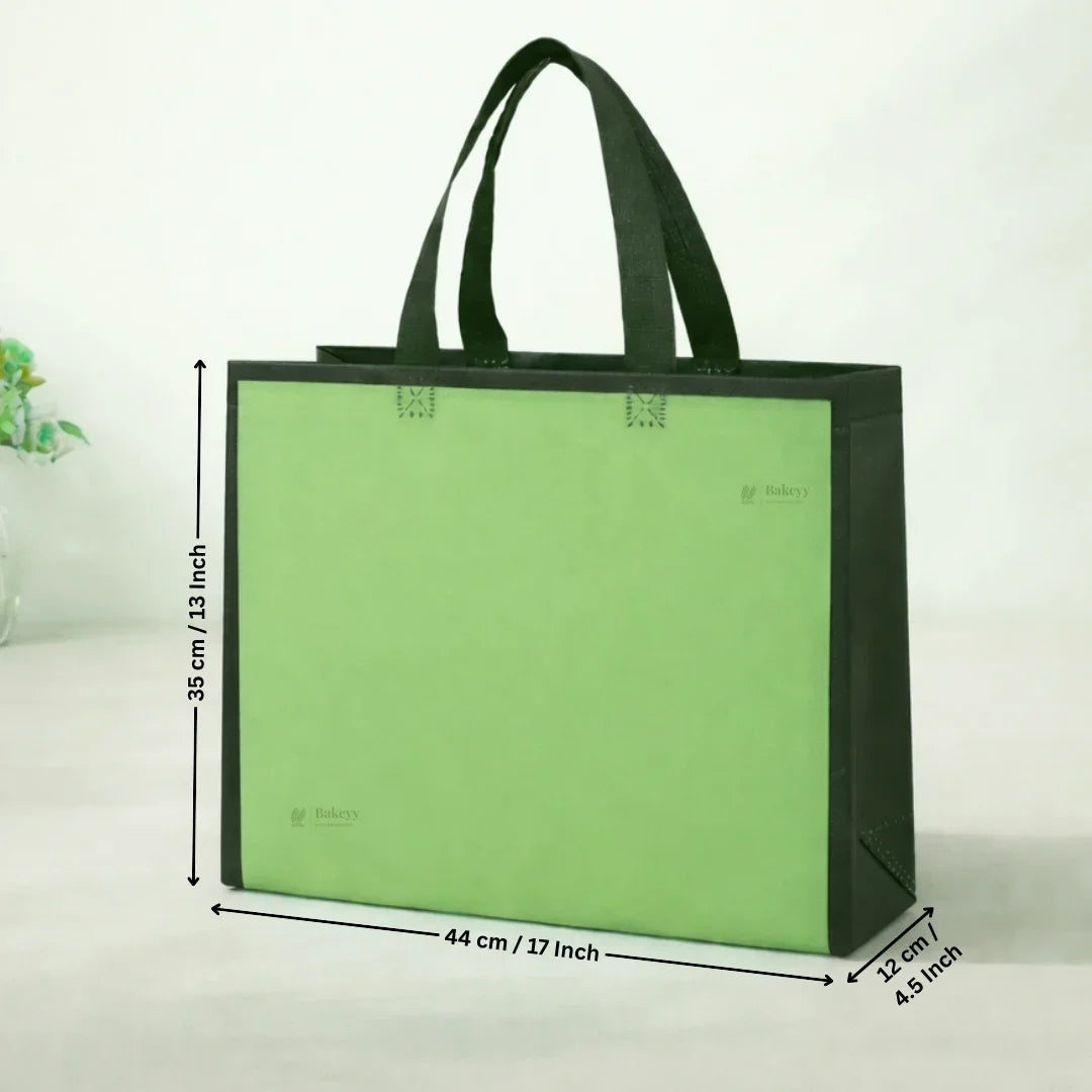 Green tote bag with dimensions on a white background