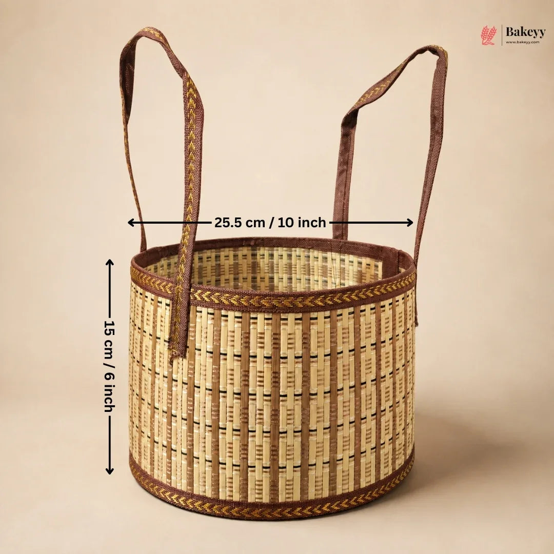 A woven round basket with two handles, shown on a plain beige background with overlaid dimension arrows and text indicating 25.5 cm / 10 inch width and 15 cm / 6 inch height.
