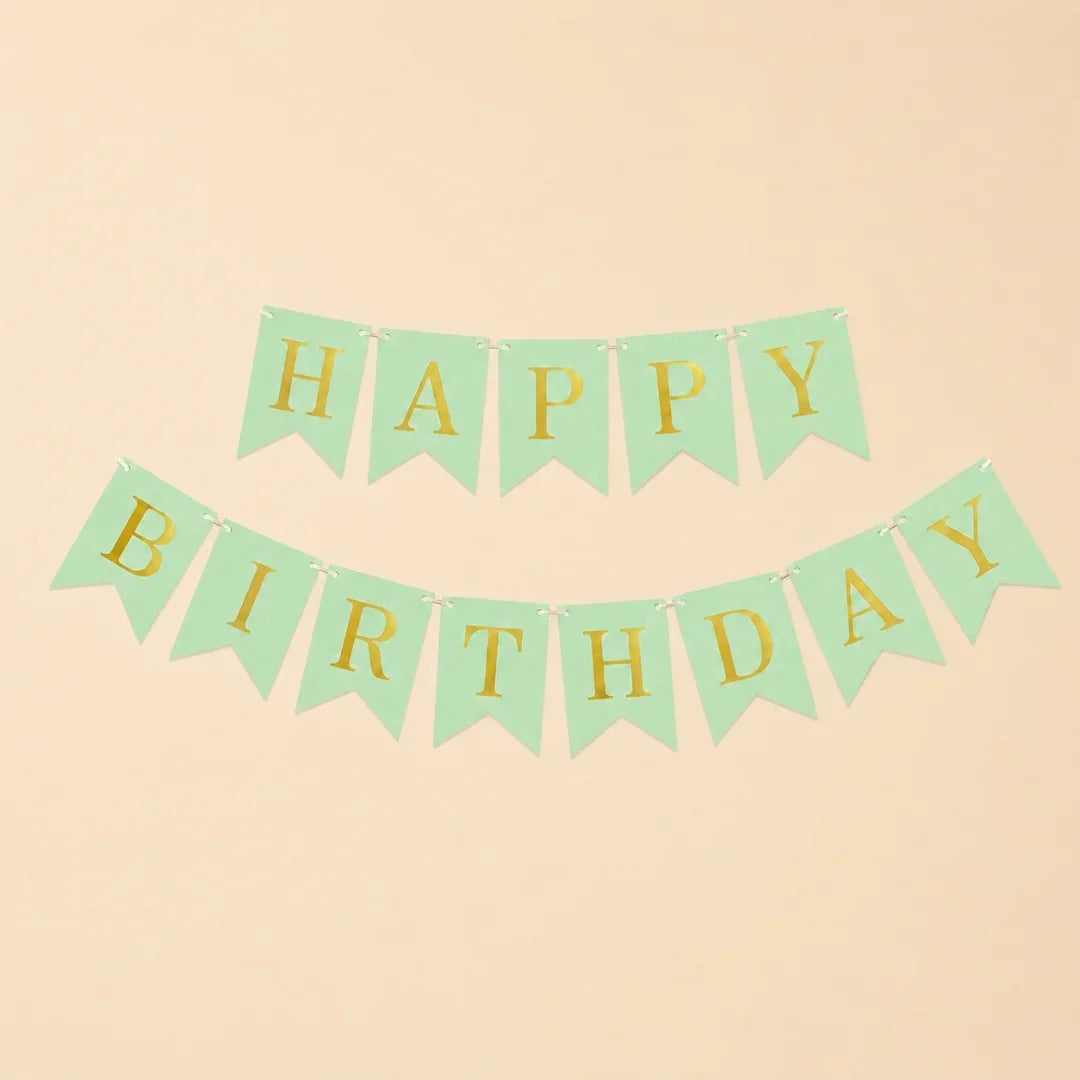 Green and gold 'Happy Birthday' banner on a beige background