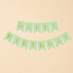 Green and gold 'Happy Birthday' banner on a beige background