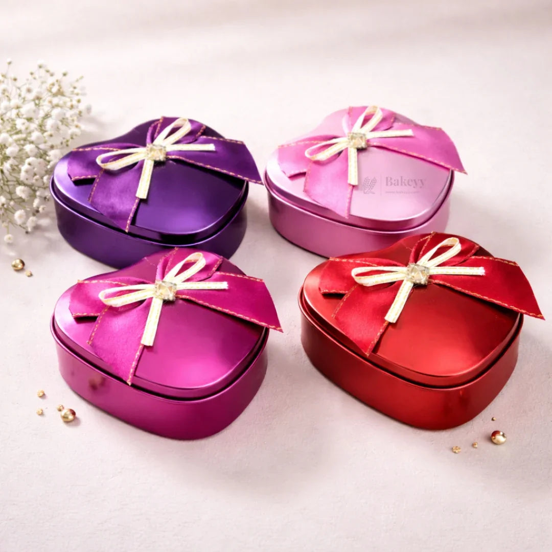 Heart-shaped gift tin boxes with satin bows in red, pink, purple on a light background, Bakeyy