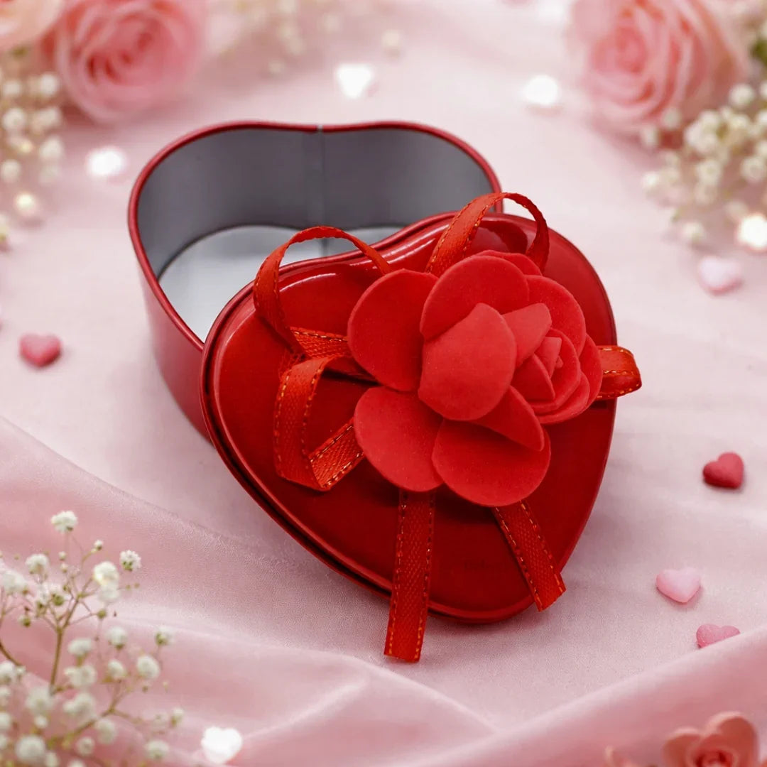 Heart-shaped red decorative tin box with flower, gift packaging from Bakeyy on pink background