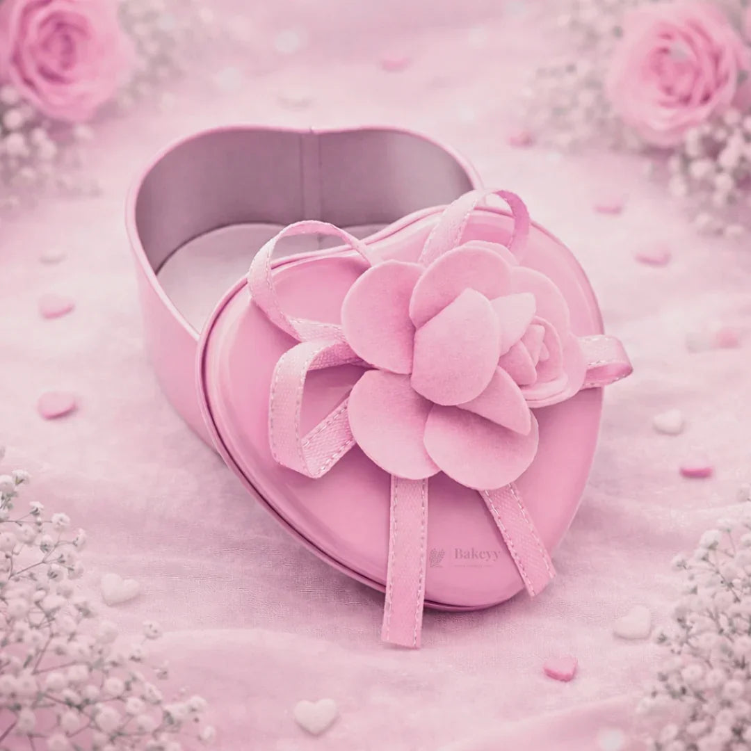Pink heart-shaped decorative tin box with flower ribbon for gift packaging from Bakeyy
