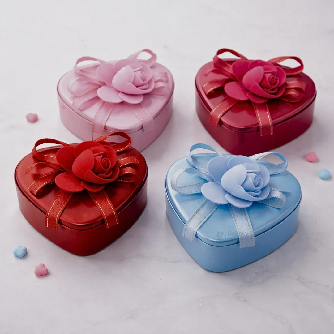 Heart-shaped decorative tin boxes with flower lids, ideal for gift packaging from Bakeyy.com
