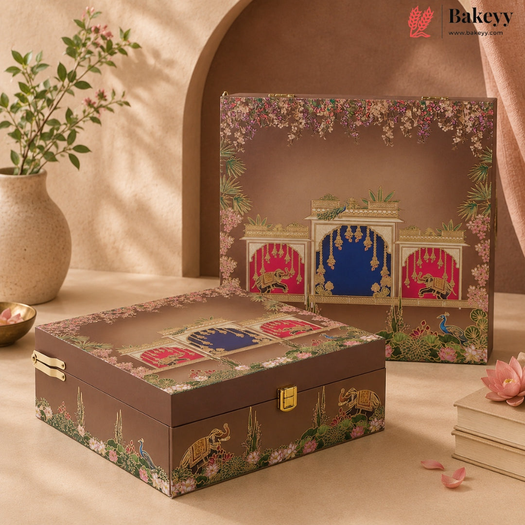 Two decorative gift boxes with a brown base and intricate multicolor printed artwork, styled on a beige surface with a vase of flowers and soft architectural background elements.