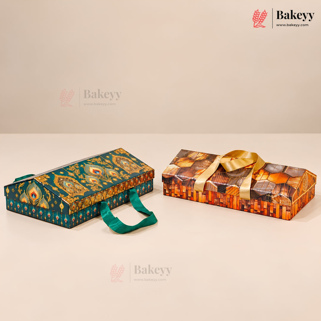 Two decorative rectangular gift boxes for baked goods on a beige studio background. The left box is teal with ornate gold and multicolor patterns and a teal handle.