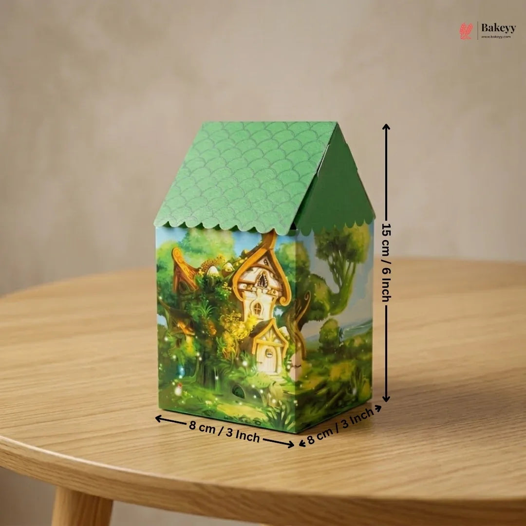 Green house-shaped box with a fairy tale design on a wooden table, featuring dimensions.