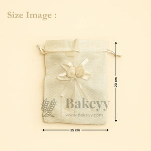 Jute potli bag with floral accents, cream color, 15x20 cm, gift packaging on Bakeyy.com