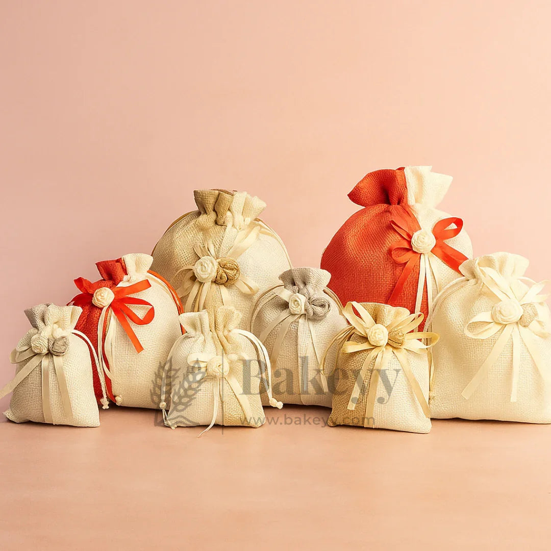 Assorted jute potli gift bags with floral accents and ribbons on a peach background, Bakeyy.com
