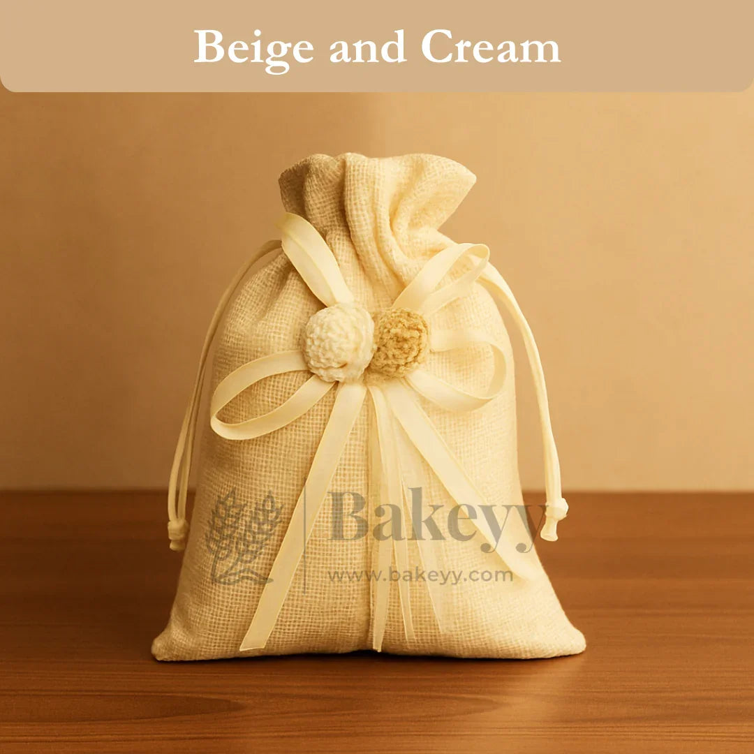 Beige and cream jute potli bag with ribbons and floral accents for gift packaging
