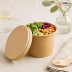 Brown paper bowl with salad on a light surface, featuring the Bakeyy brand.