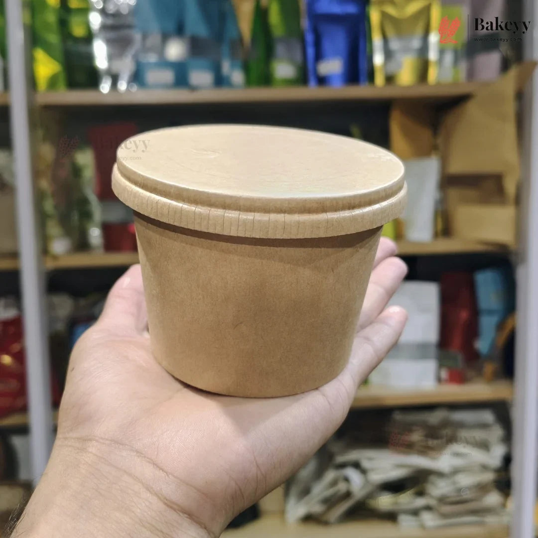 Hand holding a brown paper cup with a lid against a store shelf background