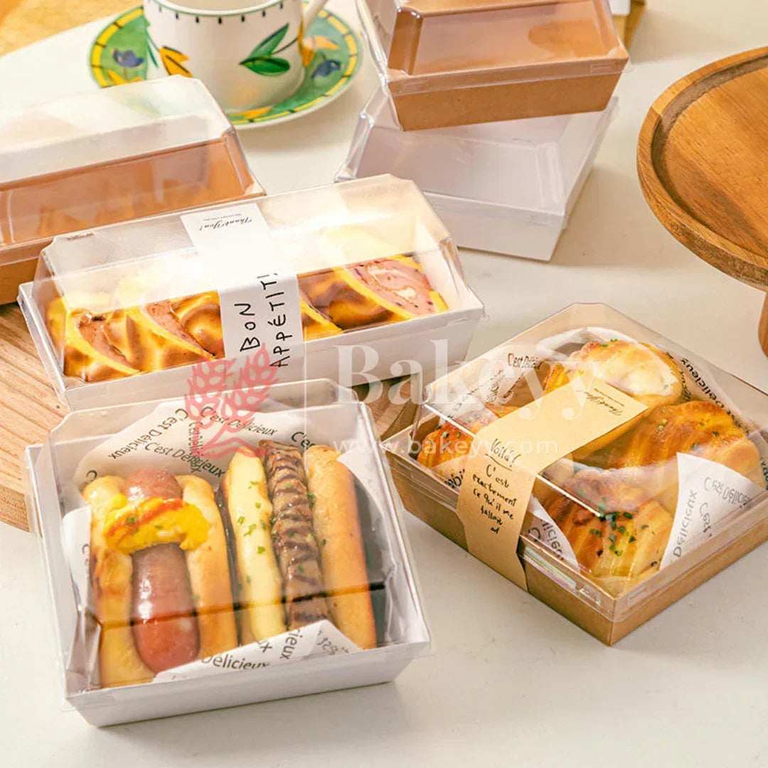 Assorted mini bread sandwiches in transparent boxes on a light surface.