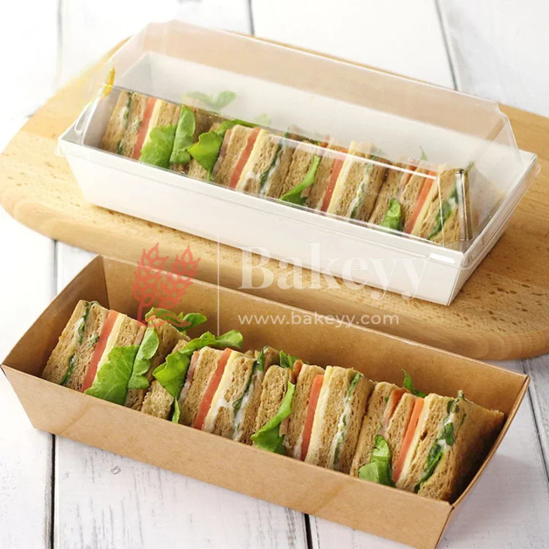 Two rectangular containers with sliced sandwiches on a wooden surface, featuring the Bakey brand.