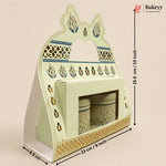 A decorative pastel green and gold ceramic tea or coffee cup holder set with two matching canisters, shown with dimension arrows and labels on a plain beige background. The Bakeyy logo appears in the top right.