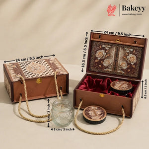 An ornate rectangular gift box set shown closed and open on a beige studio background, with measurement arrows and labels indicating dimensions. The set includes a brown patterned exterior box with rope handles, a matching open box with floral interior panels, red velvet lining, two round decorative containers, and a small clear glass jar.