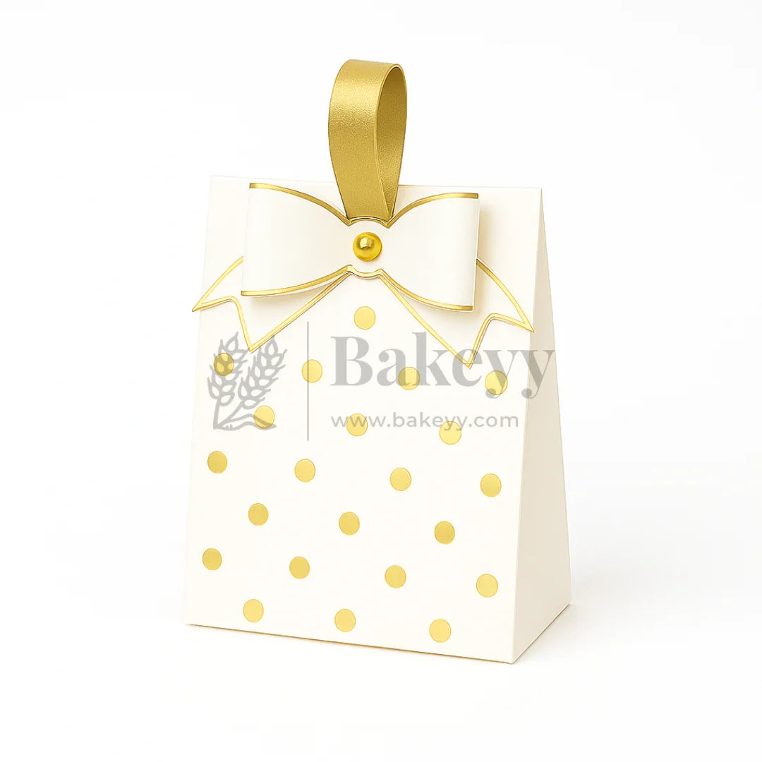 White gift bag with gold polka dots and a gold ribbon, featuring the brand 'Bakeyy'.