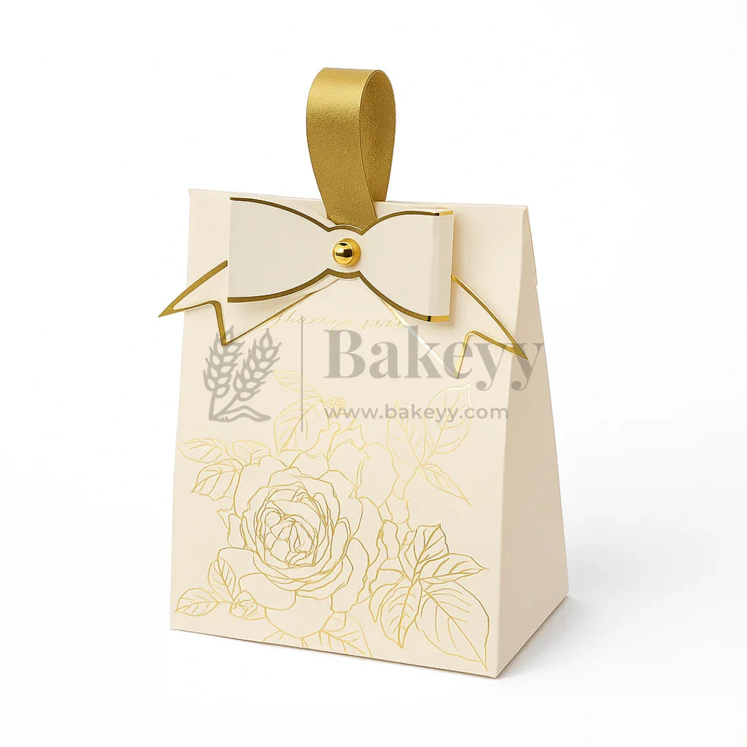 Beige gift bag with gold ribbon and floral design, featuring the brand 'Bakeyy'.
