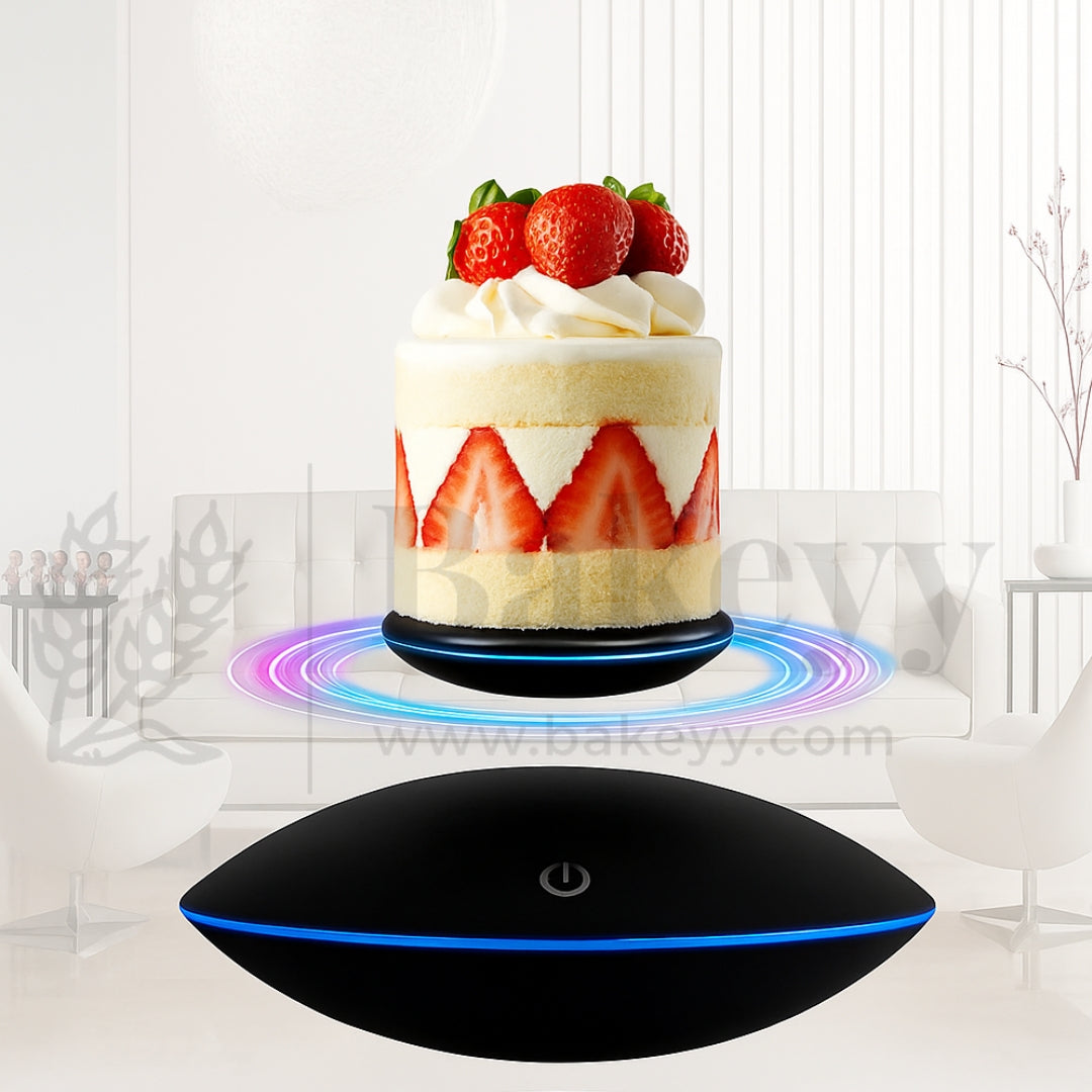Black levitating device with a cake on a white background