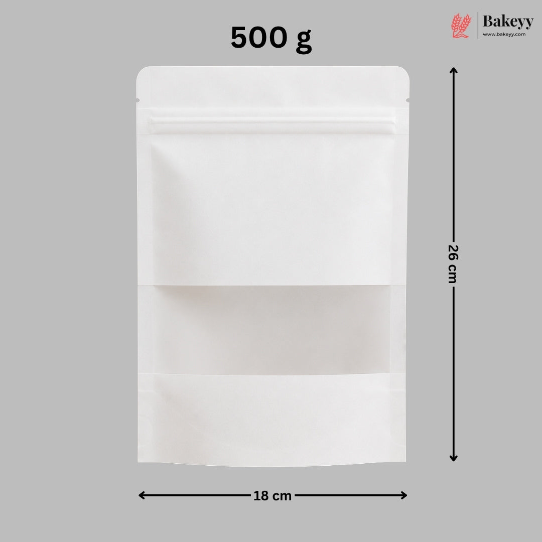 A white stand-up resealable pouch shown on a gray background with dimension arrows and text indicating 18 cm width, 26 cm height, and 500 g weight. A Bakeyy logo appears in the top right.