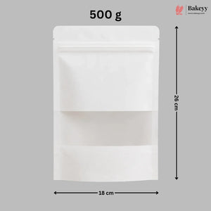 A white stand-up resealable pouch shown on a gray background with dimension arrows and text indicating 18 cm width, 26 cm height, and 500 g weight. A Bakeyy logo appears in the top right.