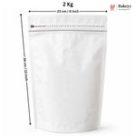 A white stand-up resealable pouch with a zipper and a small round vent hole, shown with dimension arrows indicating 23 cm width and 34 cm height, plus text reading 2 Kg and a Bakeey logo.