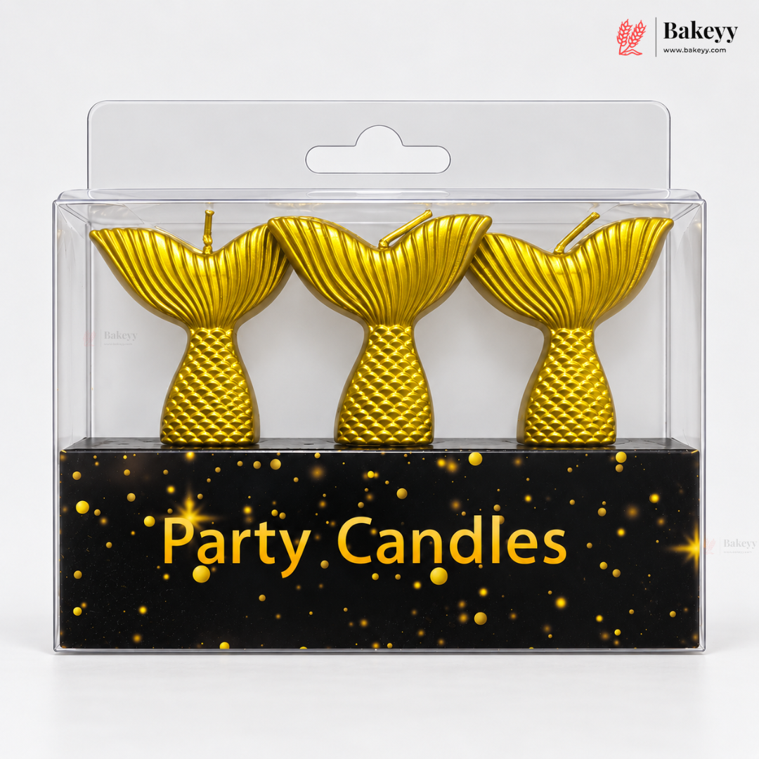 Three gold mermaid tail party candles in a clear plastic blister pack with a black backing card labeled 'Party Candles' and a Bakeyy logo in the top right.