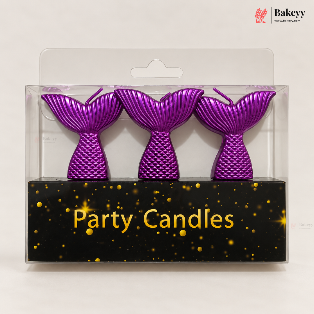 Three purple mermaid tail party candles in a clear plastic blister pack with a black base printed with the words 'Party Candles' and gold speckles. A Bakeyy logo is visible in the top right corner.