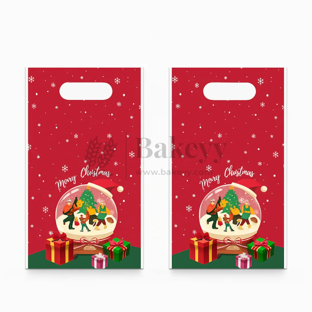 Two red Christmas gift bags with a snow globe design featuring Santa Claus, reindeer, and gifts.