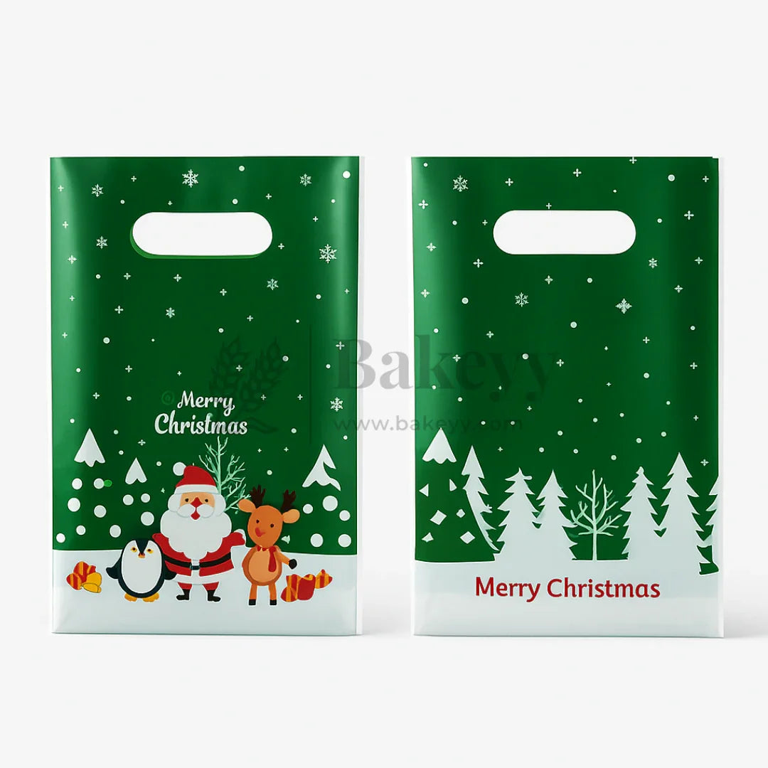 Two green Christmas-themed gift bags with Santa Claus, reindeer, penguin, and trees on a white background.