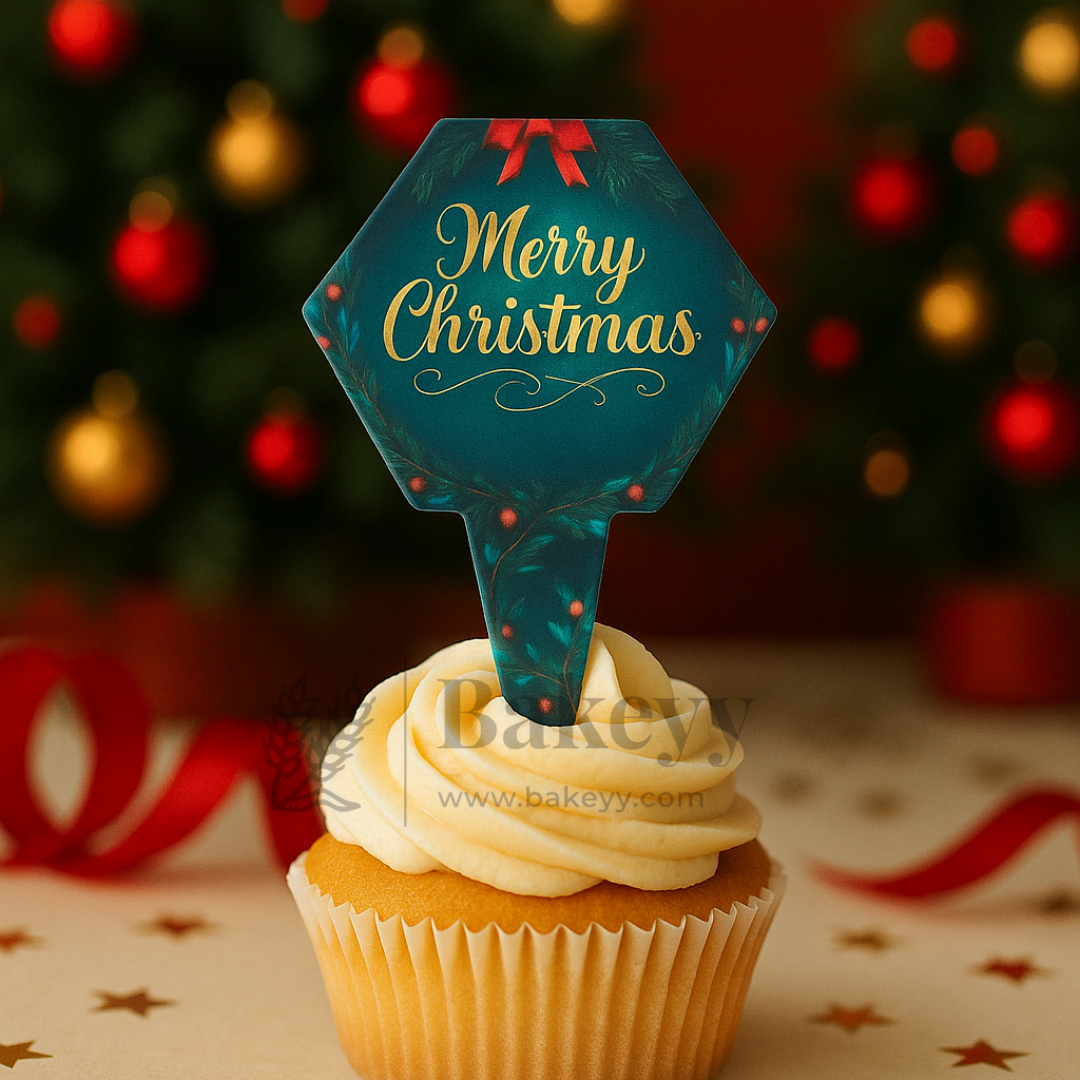 Cupcake with a 'Merry Christmas' decoration against a festive background