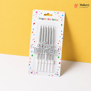 Pack of birthday candles with 'Happy Birthday' text on a yellow background