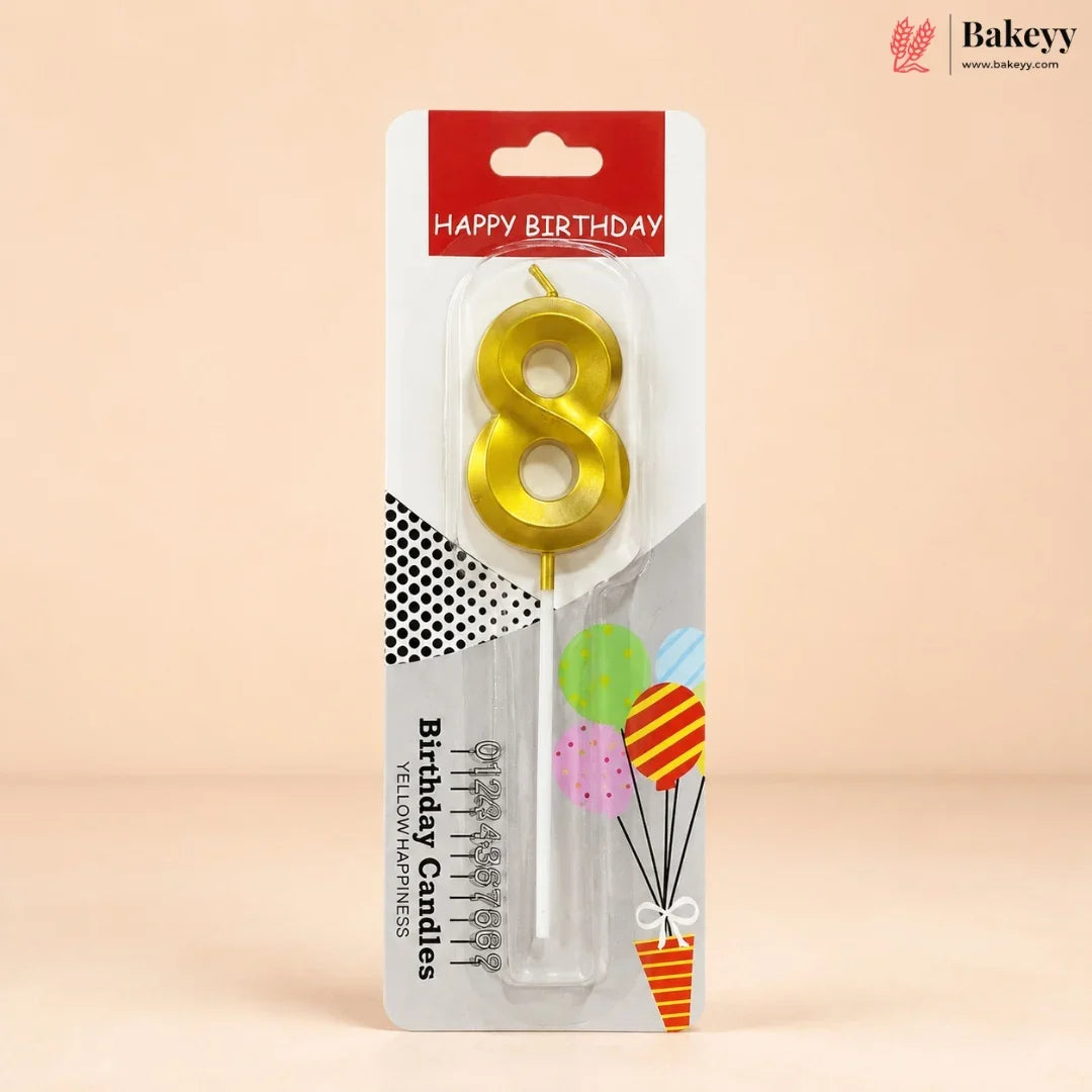 An 8-shaped yellow candle in its retail packaging, featuring a red and white header that reads 'HAPPY BIRTHDAY' and decorative graphics on a beige background.