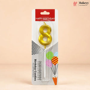 An 8-shaped yellow candle in its retail packaging, featuring a red and white header that reads 'HAPPY BIRTHDAY' and decorative graphics on a beige background.