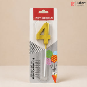 A yellow number 4 birthday candle in its original retail packaging, featuring a red 'HAPPY BIRTHDAY' header and festive graphics on a beige background.