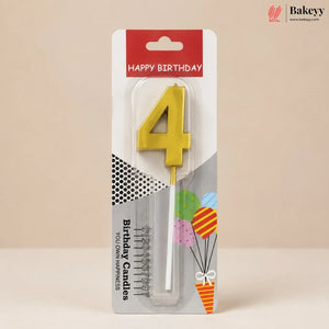 A yellow number 4 birthday candle in its original retail packaging, featuring a red 'HAPPY BIRTHDAY' header and festive graphics on a beige background.