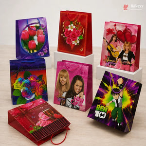 Collection of colorful gift bags with various designs on a light surface.