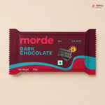 Dark chocolate bar packaging with 'morde' branding on a beige background