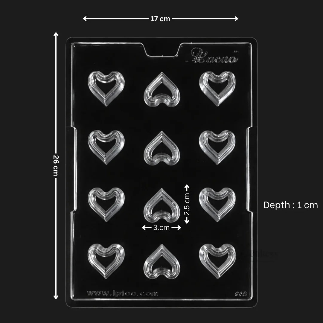 Clear plastic hollow heart chocolate mould tray with 12 cavities, baking accessory from Bakeyy India