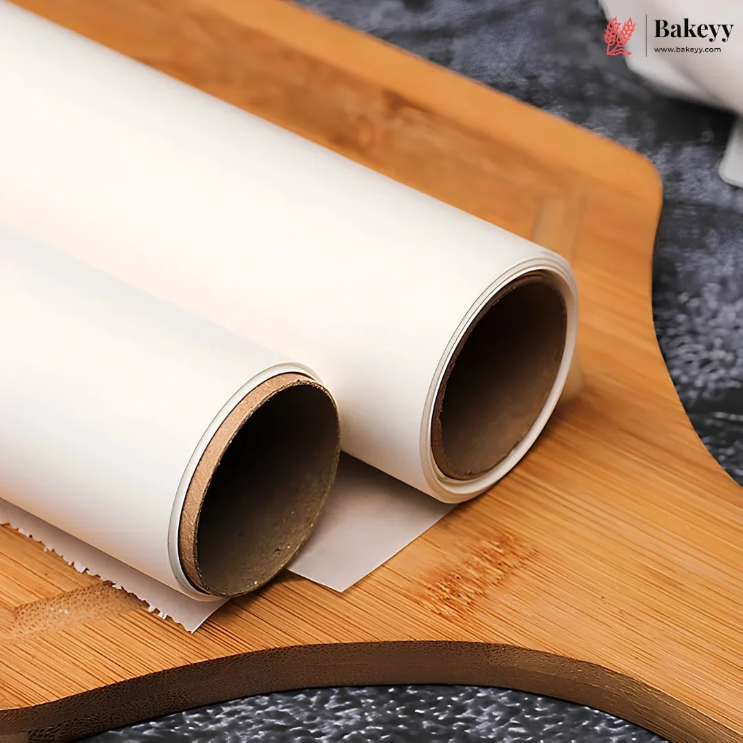 Two rolls of white parchment paper on a wooden cutting board, with a baking sheet partially unrolled. A 'Bakeey' brand logo is visible in the top right corner.