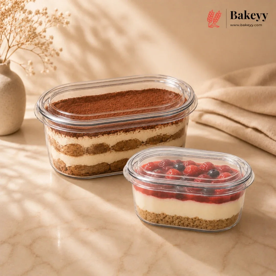 Two dessert containers with layered fillings on a beige surface, featuring the Bakeyy brand.