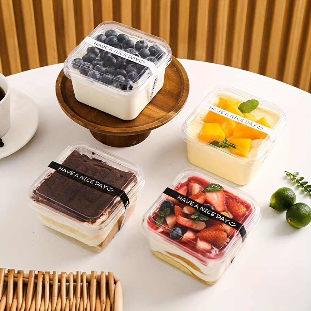Assorted dessert boxes with 'Have a Nice Day' branding on a white table.