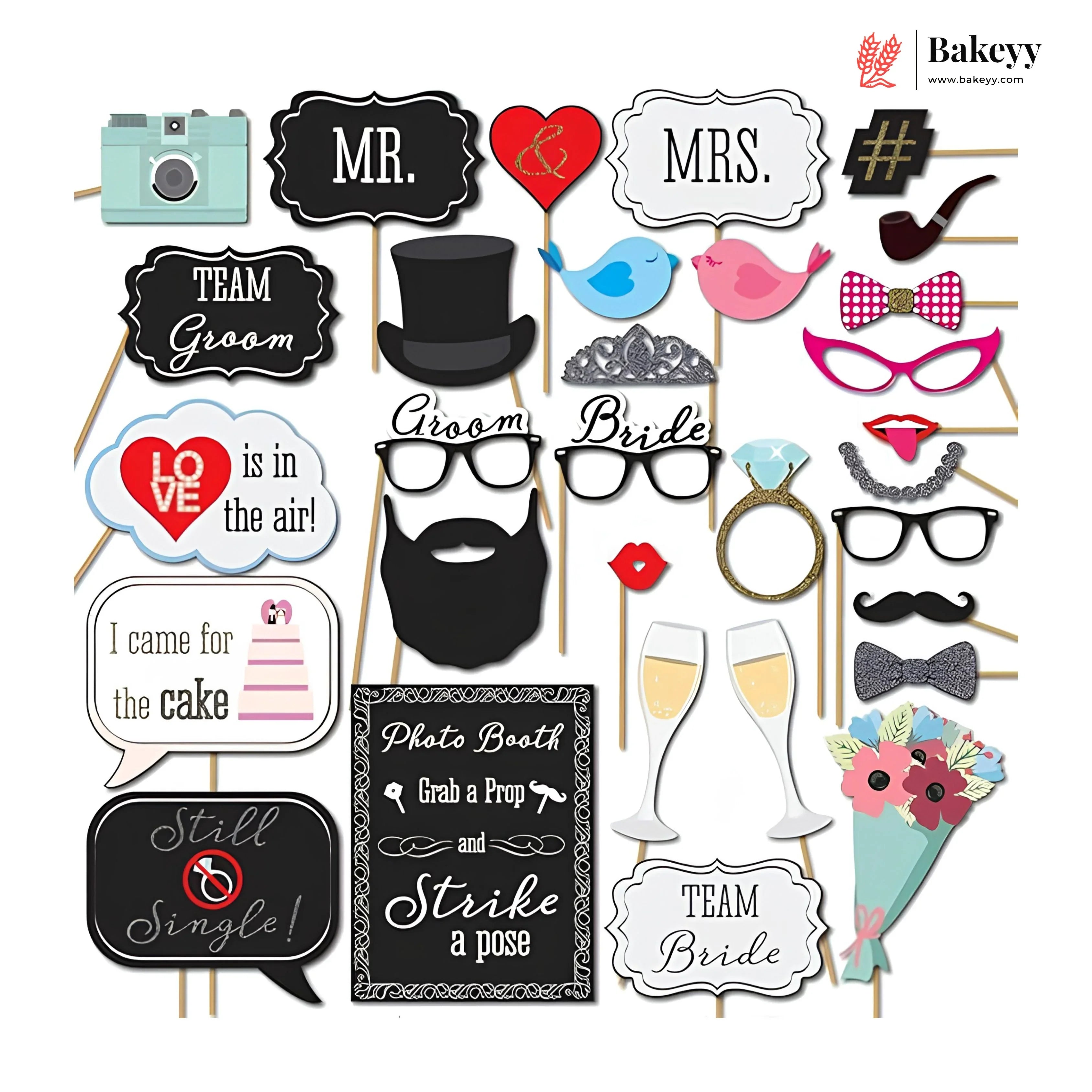 Collection of photo booth props with various items on sticks against a white background.