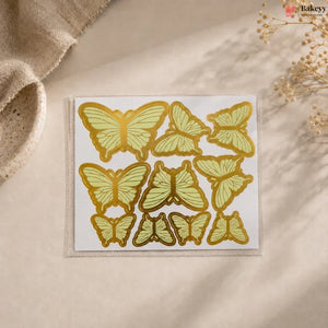 Pack of butterfly-shaped stickers on a beige surface with a natural background