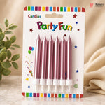 Pack of pink birthday candles with colorful packaging on a neutral background