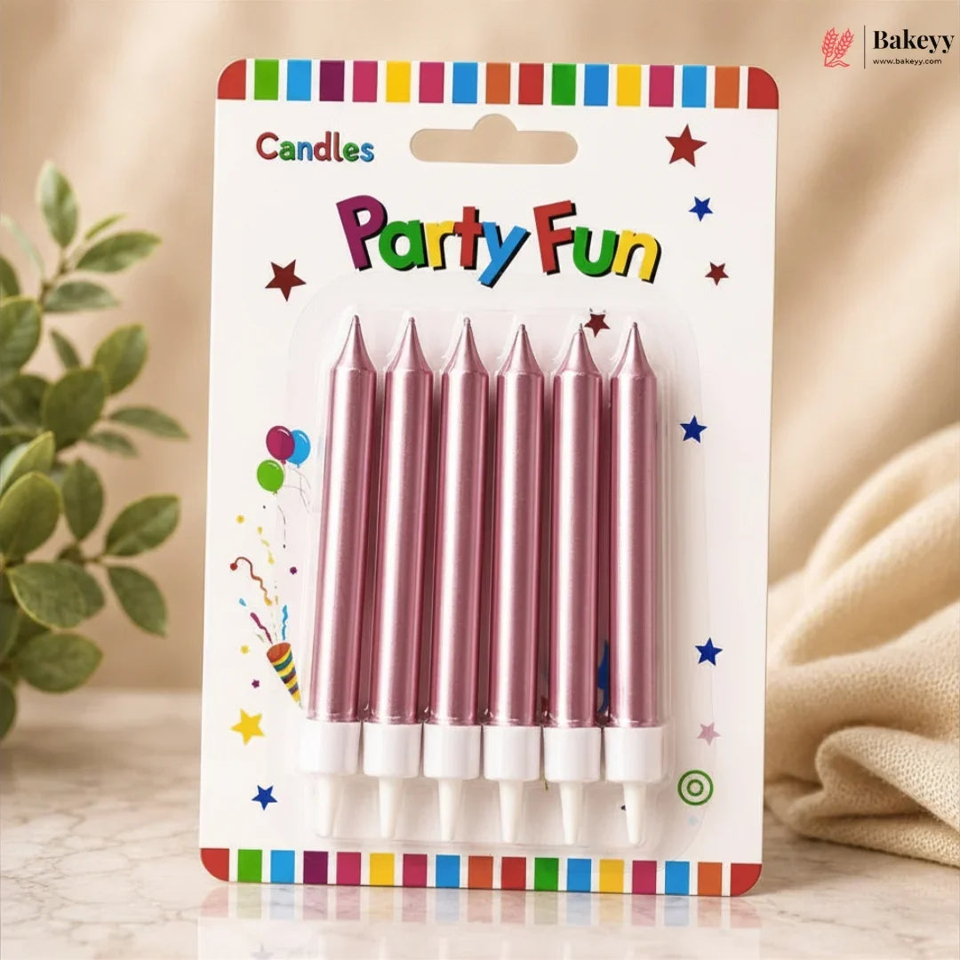 Pack of pink birthday candles with colorful packaging on a neutral background