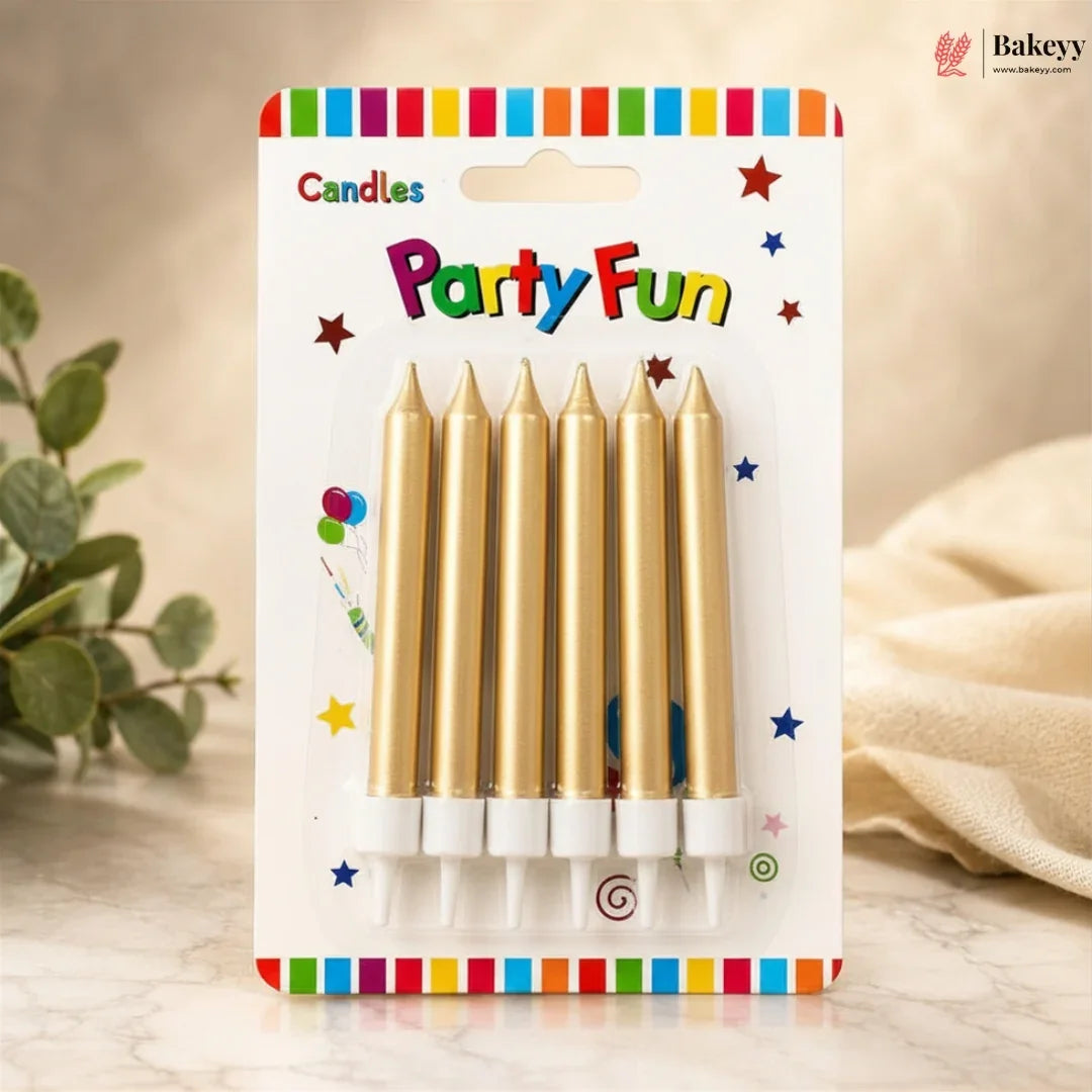 Pack of gold candles with 'Party Fun' packaging on a wooden surface.
